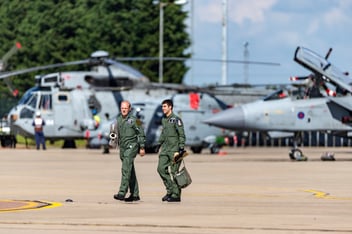 Two RAF pilots walking in front of airplanes